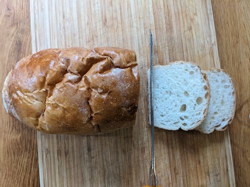 La lame du couteau électrique qui vient de couper 2 tranches du pain de mie