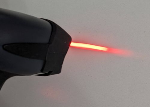 Le lecteur en fonctionnement sans éclairage LED&nbsp;: seul le laser rouge est visible.