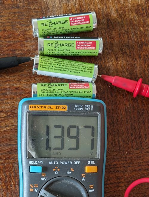 Multimètre affichant 1,397 V pour les piles AA après la charge